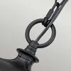 A close-up view of the black metal chain and ring of a pendant light fixture. Produktbild-Vorschau