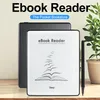 An ebook reader and stylus are displayed on a wooden surface with a plant in the background. Náhled obrázku produktu