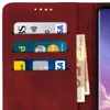 A close-up view of a red wallet-style phone case with credit cards and banknotes inserted. Produktbild-Vorschau