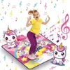 A young girl is joyfully jumping on a colorful unicorn-themed dance mat, surrounded by musical notes. Produktbild-Vorschau
