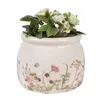 A ceramic pot with a floral design and white flowers inside, isolated on a white background. Náhľad obrázku produktu