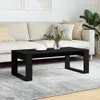 A black coffee table is placed in front of a sofa in a living room setting. Náhľad obrázku produktu