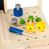 A close-up view of a wooden toy workbench with various tools and building components. Náhled obrázku produktu