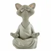 A gray cat figurine in a meditative pose, wearing a robe. Produktbild-Vorschau