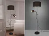 A floor lamp with an adjustable reading light is shown in two different settings: one in a living room with furniture and another against a plain background. Produktbild-Vorschau