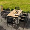 An outdoor dining set on a wooden deck with a grassy background. Náhled obrázku produktu