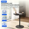 A modern, minimalist side table with a black top and base, placed in a well-lit room with a large window and sheer curtains. Decorative elements like a vase with dried flowers, a magazine, and a cup of coffee are on the table. Anteprima dell’immagine prodotto