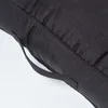 A close-up view of a black cushion with a fabric handle. Náhled obrázku produktu