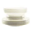 A stack of white ceramic plates and bowls. Produktbild-Vorschau