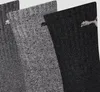 A close-up view of three pairs of PUMA crew socks in different shades of gray and black. Anteprima dell’immagine prodotto