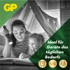 A mother and child are in a tent made of blankets, reading a book with a flashlight. Produktbild-Vorschau