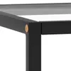 A close-up view of the corner of a black metal frame table with a glass top. Náhled obrázku produktu