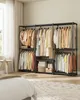 A bedroom scene with an open wardrobe system filled with clothing. Produktbild-Vorschau