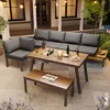 An outdoor patio setting at dusk with a lounge set, table, and bench. Podgląd zdjęcia produktu