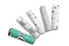 A set of rolled-up baby muslin cloths with different patterns, laid out diagonally on a white background. Produktbild-Vorschau
