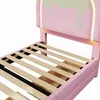 A close-up view of the headboard and slatted base of a pink bed frame. Produktbild-Vorschau