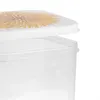 A close-up view of a clear plastic food storage container with a lid featuring a dandelion print. Produktbild-Vorschau