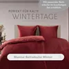 A bed with red bedding. Anteprima dell’immagine prodotto
