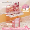 A pink children's vanity set with a mirror, shelves, drawers, and a chair, displayed in a room setting with toys and decor. Podgląd zdjęcia produktu
