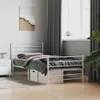 A bedroom scene with a white metal bed frame, bedding, and a nightstand. Podgląd zdjęcia produktu
