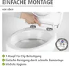 A person's hand is shown attaching a toilet seat to a toilet bowl. Produktbild-Vorschau