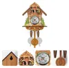 A cuckoo clock with decorative elements and a clock face, shown with close-up views of its details. Náhled obrázku produktu