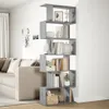 A gray bookshelf with books and decorative items in a living room next to a sofa. Anteprima dell’immagine prodotto