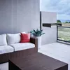 An outdoor patio with modern furniture and a view of the water. Voir les images du produit