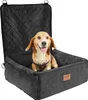A dog sits in a black car seat booster. Náhled obrázku produktu