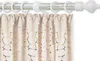 A close-up of a curtain rod with rings and a curtain with a gold pattern. Produktbild-Vorschau