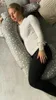 A pregnant woman is sleeping on her side, using a large, star-patterned pregnancy pillow for support. Náhľad obrázku produktu