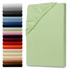 A stack of folded sheets in various colors is shown on the left, and a single green fitted sheet is displayed on the right. Produktbild-Vorschau