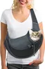 A woman is wearing a gray pet carrier sling bag with a cat peeking out. Produktbild-Vorschau