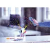 A hand is wiping a glass surface with colorful drawings of fireworks and markers in a glass holder. Anteprima dell’immagine prodotto