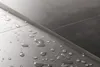 Water droplets on a tiled surface with a metal strip. Náhľad obrázku produktu