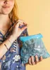 A person holding a bag of cookies and one cookie. Produktbild-Vorschau