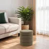 A living room scene with a sofa, a plant, and a storage ottoman. Produktbild-Vorschau