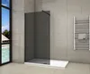 A modern bathroom with a walk-in shower, towel rack, and a large window overlooking a tropical scene. Produktbild-Vorschau