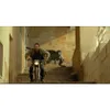 A man rides a motorcycle down a set of stairs while being chased by a dinosaur. Náhled obrázku produktu