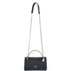 A black Guess handbag with a silver chain strap is shown against a white background. Produktbild-Vorschau
