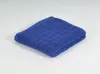 A folded blue towel on a white background. Produktbild-Vorschau