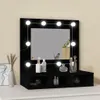 A black vanity table with lights and a mirror, displaying makeup products. Produktbild-Vorschau