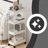 A white four-tier rolling cart filled with various items, placed next to a sofa. Podgląd zdjęcia produktu