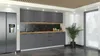 A modern kitchen with gray cabinets and a stainless steel refrigerator. Voir les images du produit