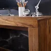 Close-up of a wooden desk surface with a marble-patterned backing. Produktbild-Vorschau