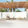 An outdoor patio area with a retractable side awning, furniture, and tropical plants. Produktbild-Vorschau