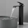 A black waterfall faucet is shown in use, with water flowing into a grey basin. Produktbild-Vorschau