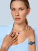 A woman wearing jewelry and a watch. Produktbild-Vorschau