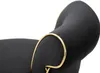 A close-up view of a black bar stool with gold trim. Podgląd zdjęcia produktu