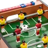 A close-up view of a mini foosball table with players and a ball. Podgląd zdjęcia produktu